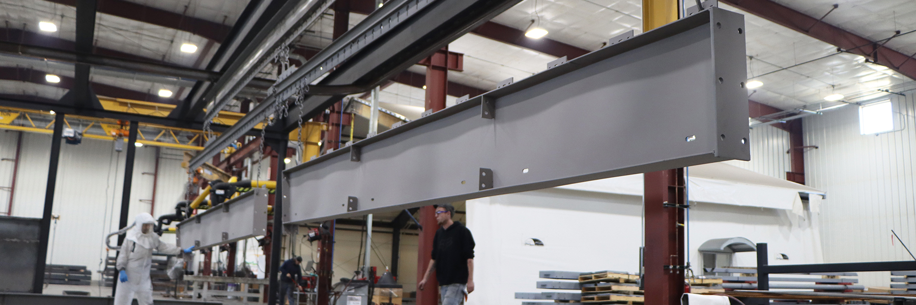 PPG Painted Beams being hung in our warehouse