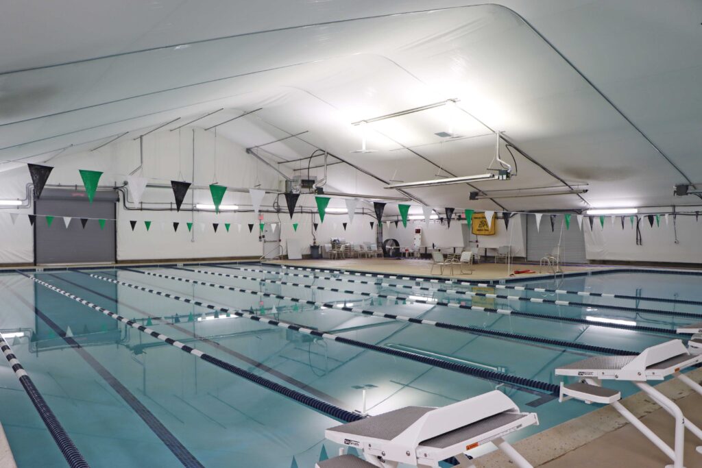 swimming pool with seating area in fabric building