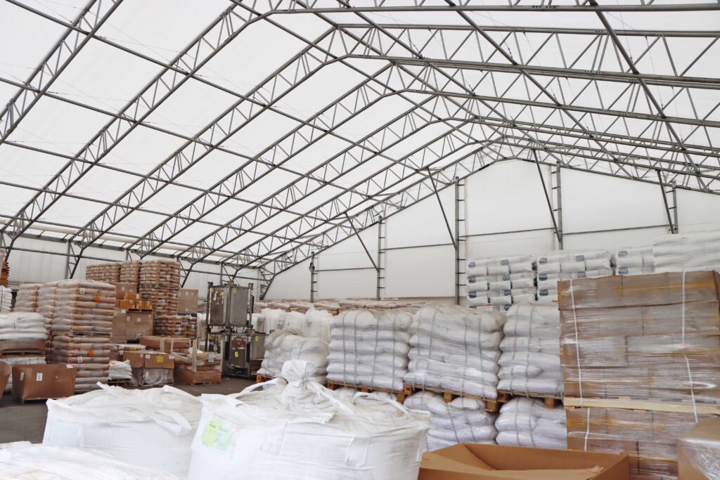 interior of fabric storage shelter with stacked goods