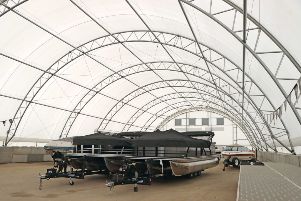 boats being stored inside fabric storage tent