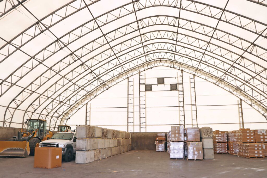 fabric storage shelter protecting vehicle and bulk goods