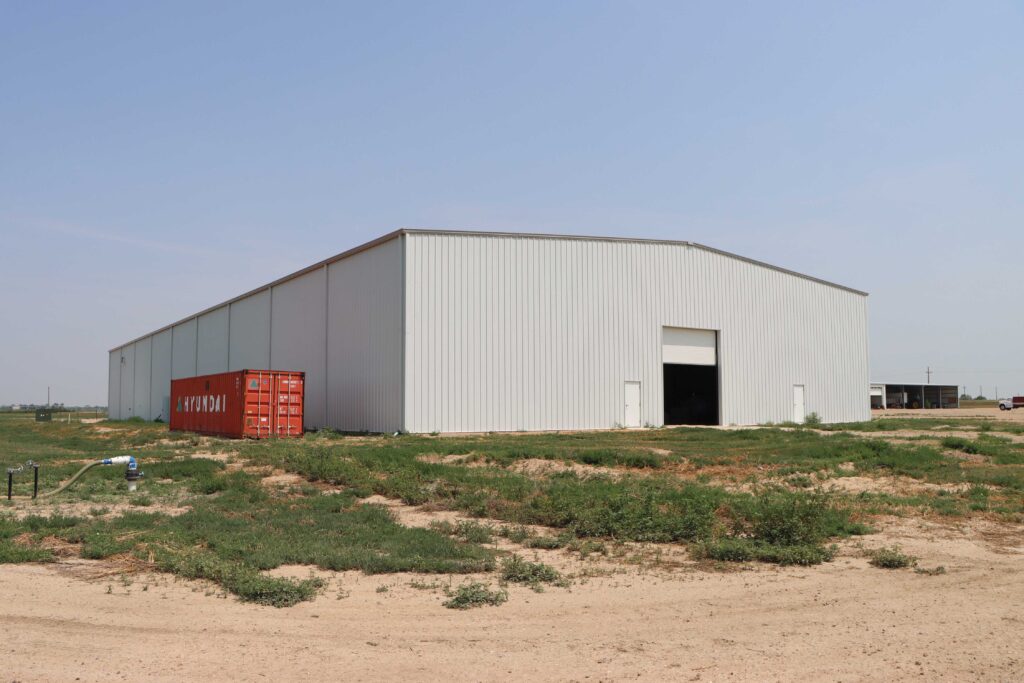 metal building on wide-open, dry terrain