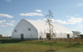 fabric structure with wood fencing on the outside