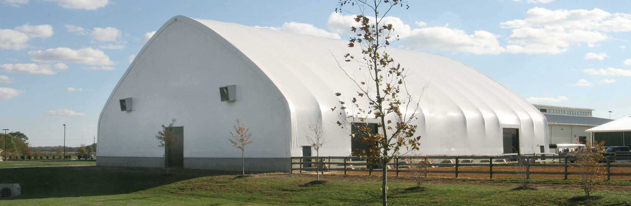 fabric structure with wood fencing on the outside