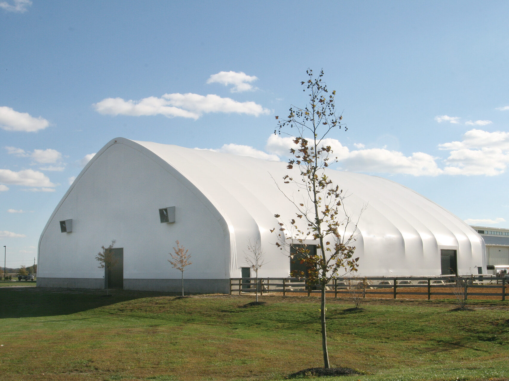 fabric structure with wood fencing on the outside