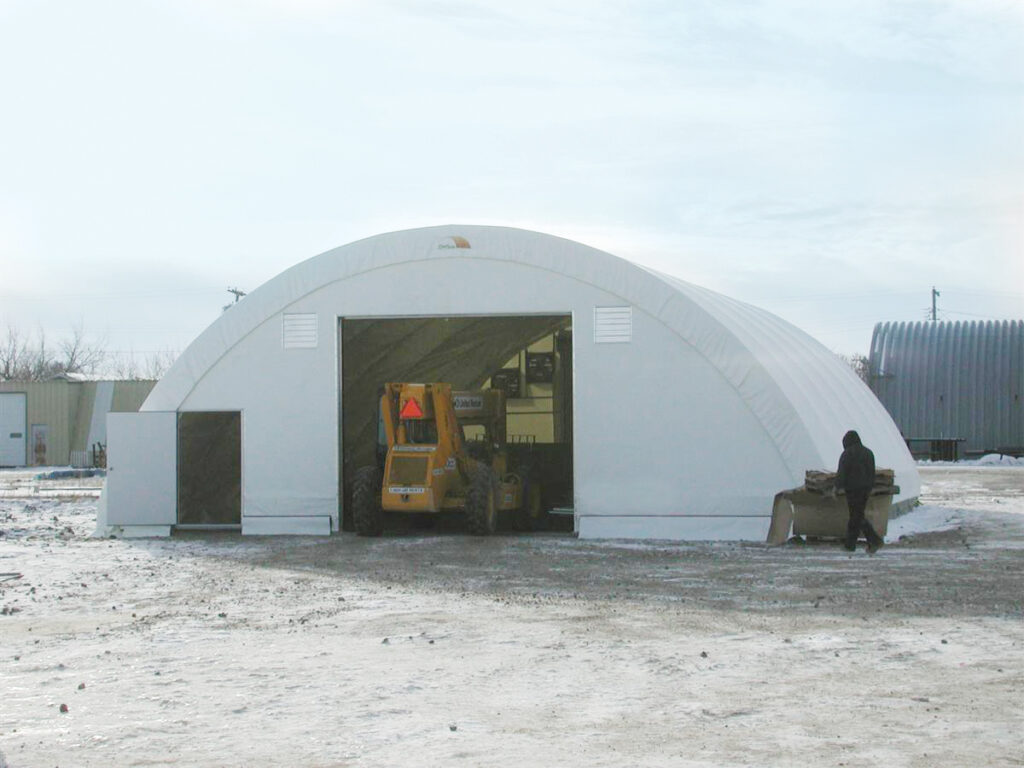 construction equipment entering fabric shelter