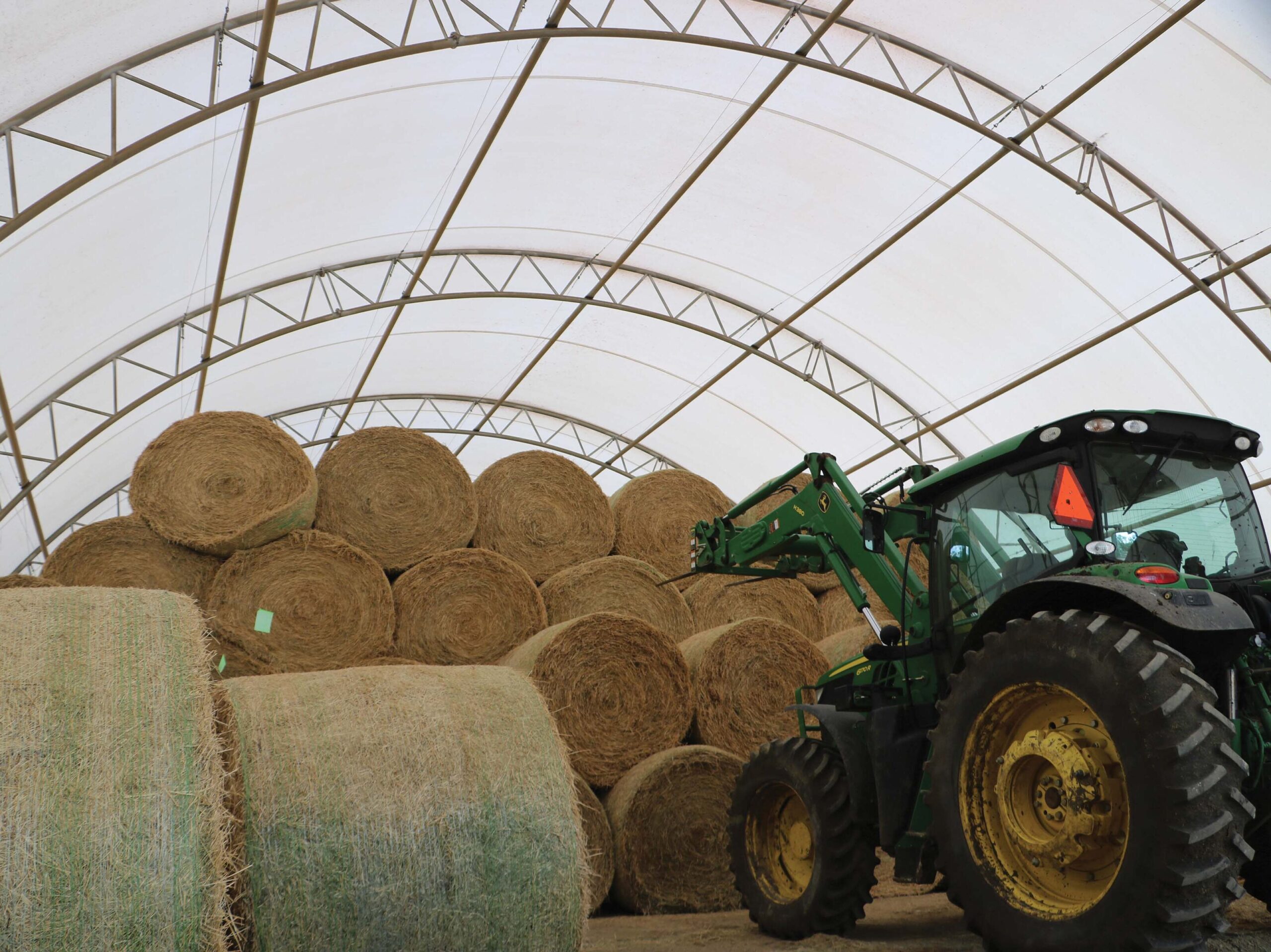 Hay storage with green tractor