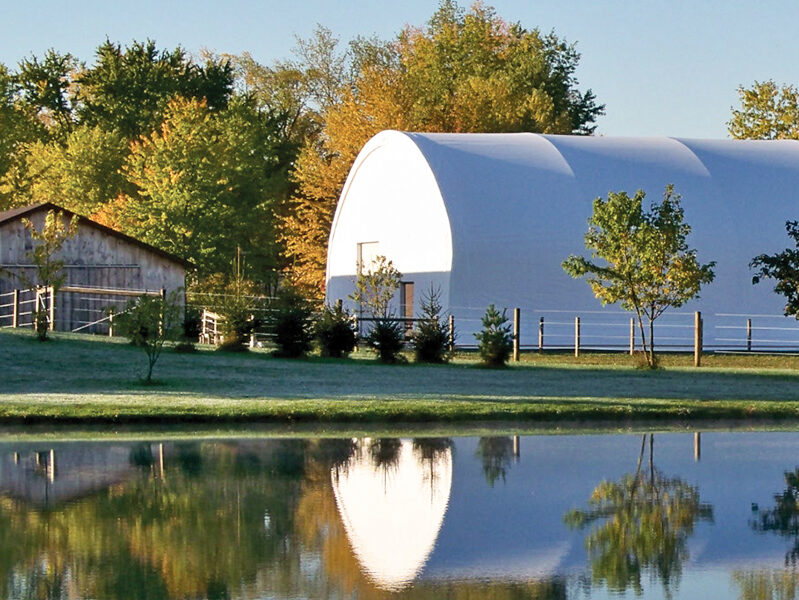 Fabric building reflected off a pond