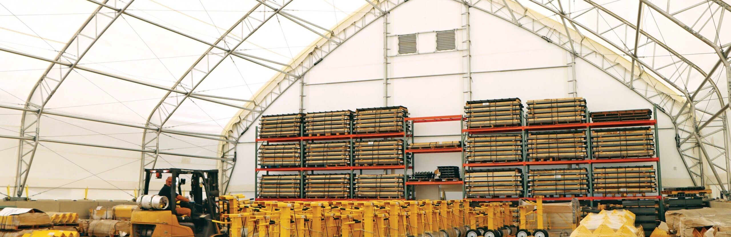 stored goods and forklift inside fabric warehouse