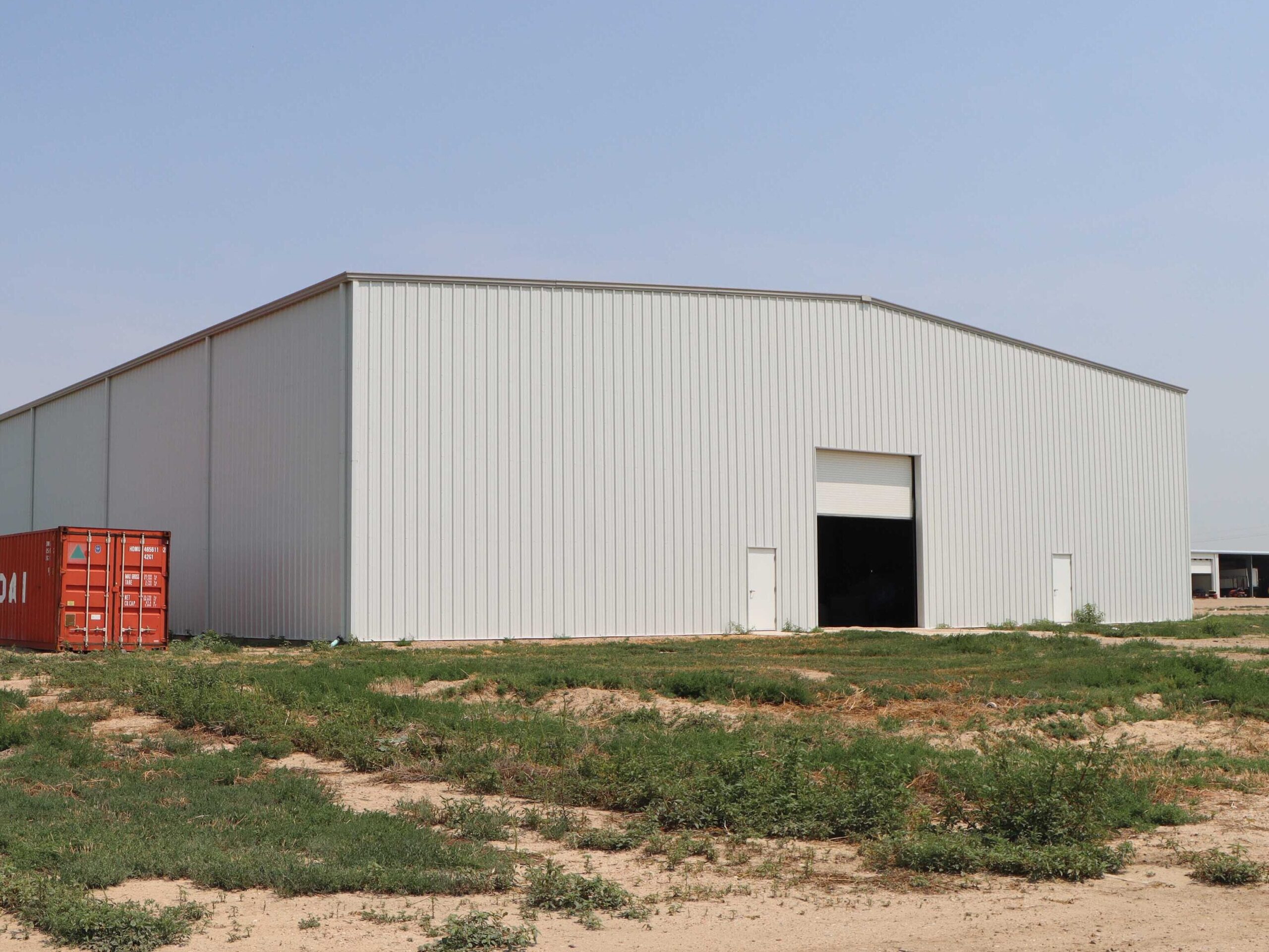 gray insulated steel building with roll up door