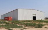 gray insulated steel building with roll up door
