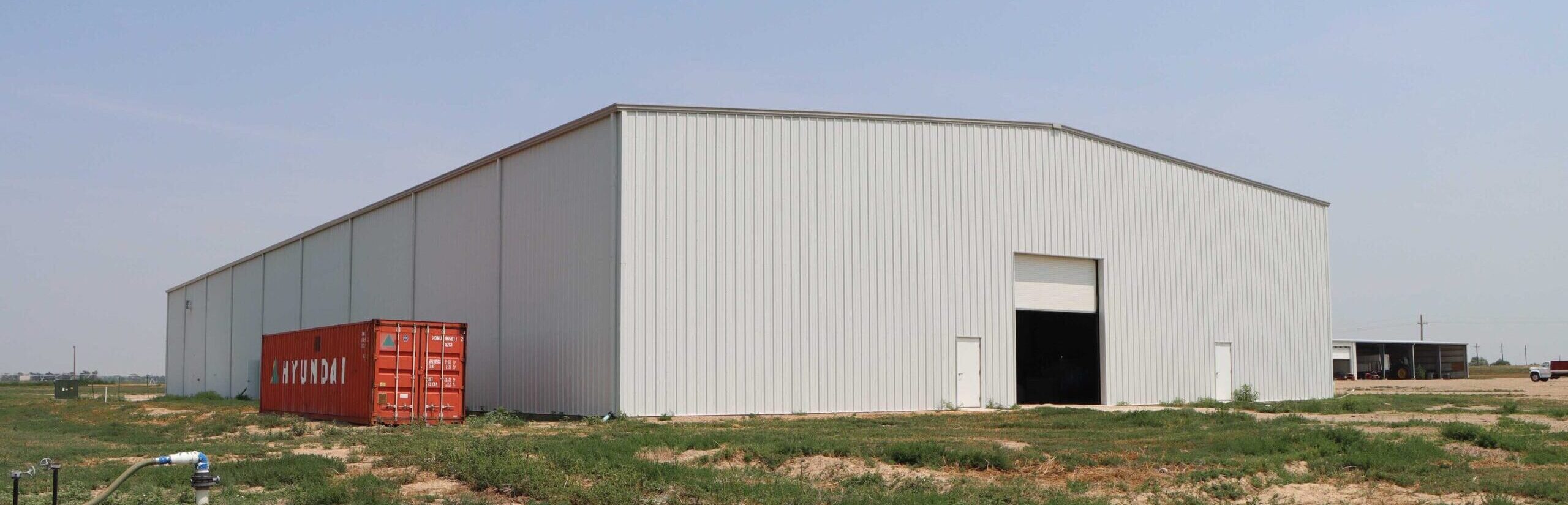 gray insulated steel building with roll up door