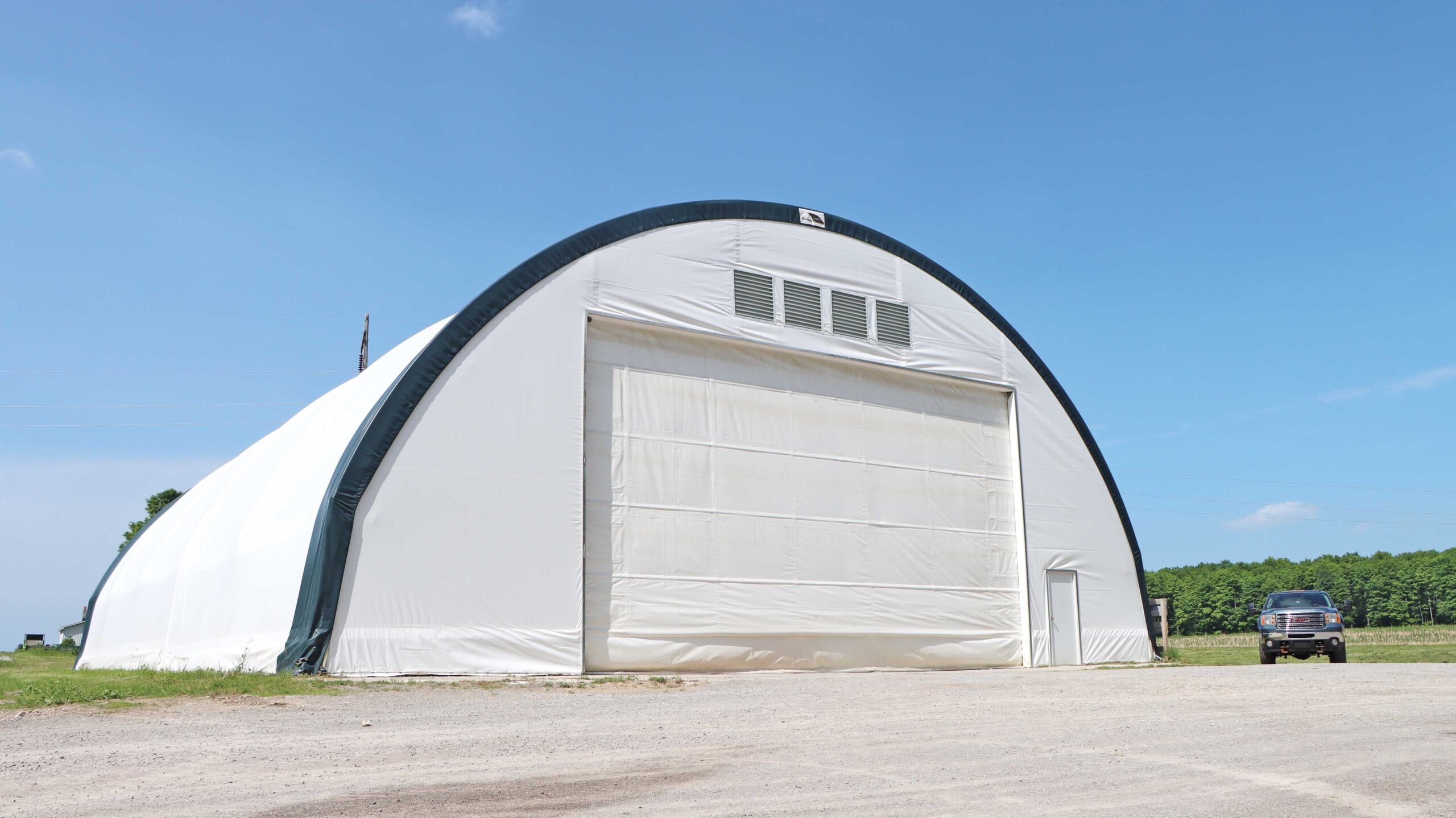 white round hd fabric building with giant roll up door