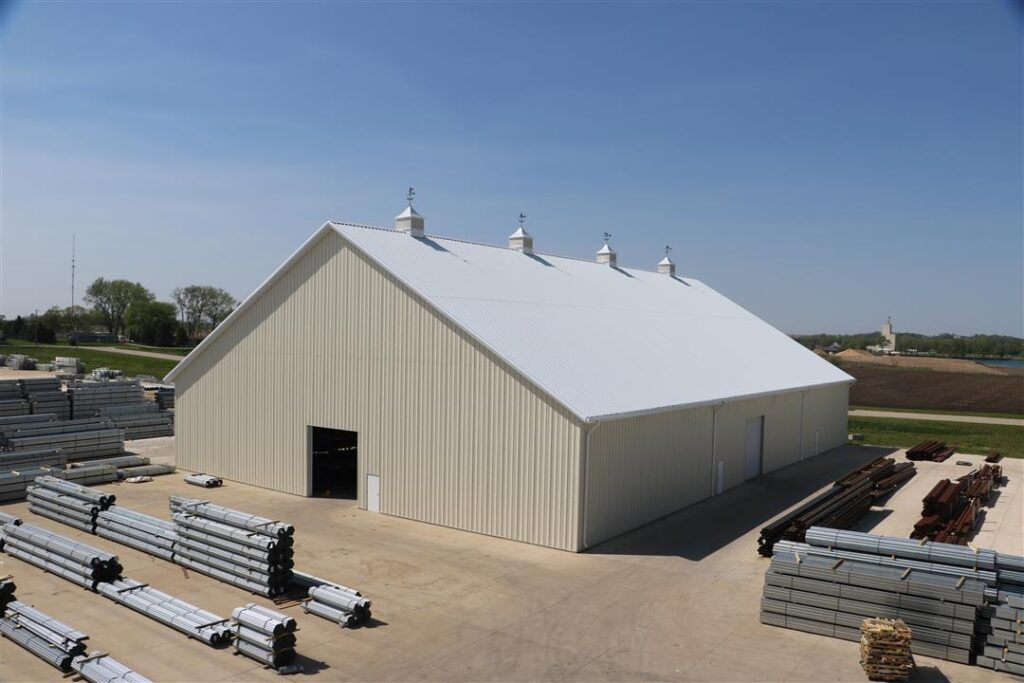 Outside tan metal building with panel roof