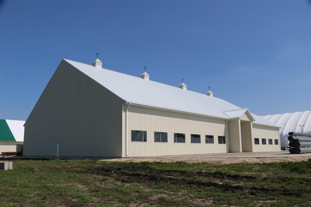 Outside tan metal building with panel roof