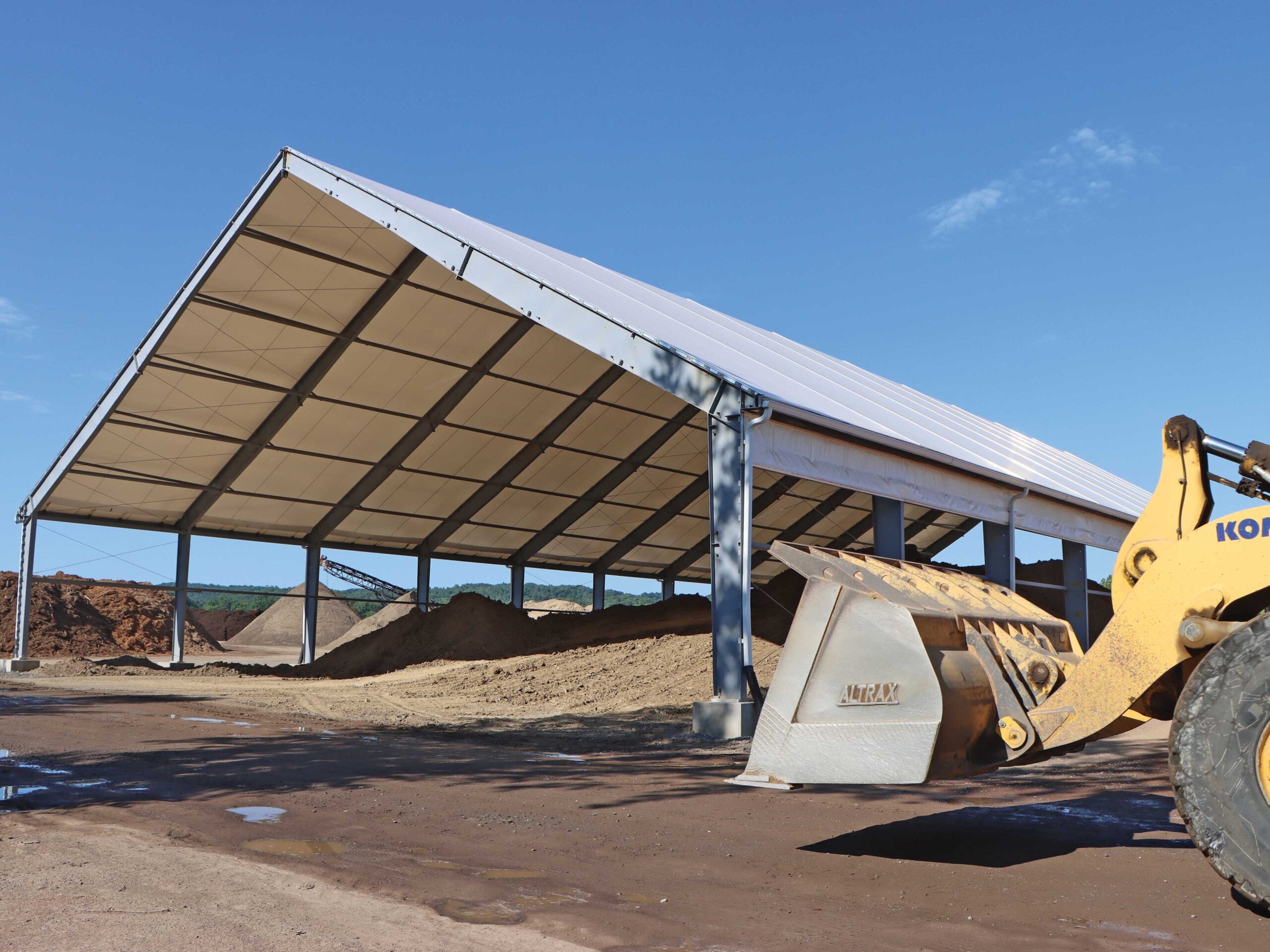 fabric beam building housing soil with vehicle entering shot