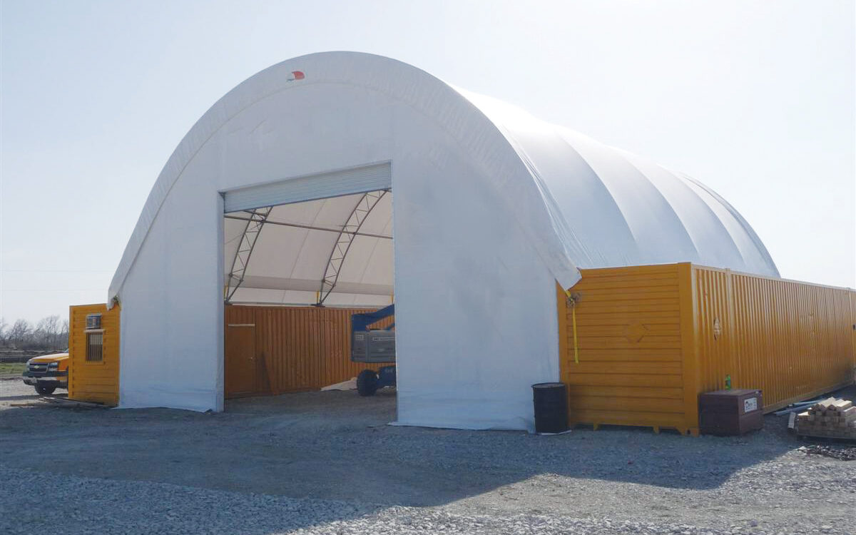 ClearSpan truss building mounted on shipping containers