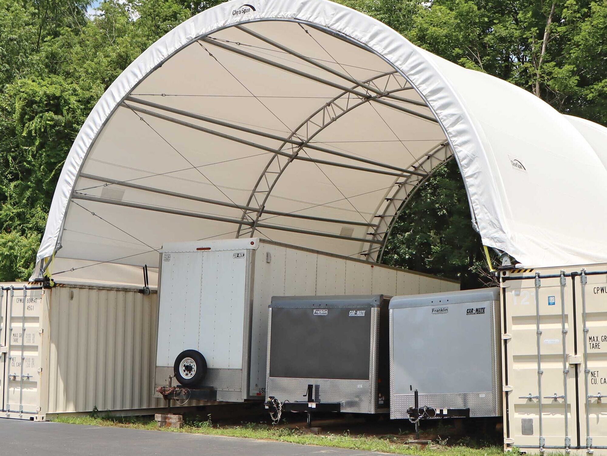 fabric tent shed with trailers stored underneath