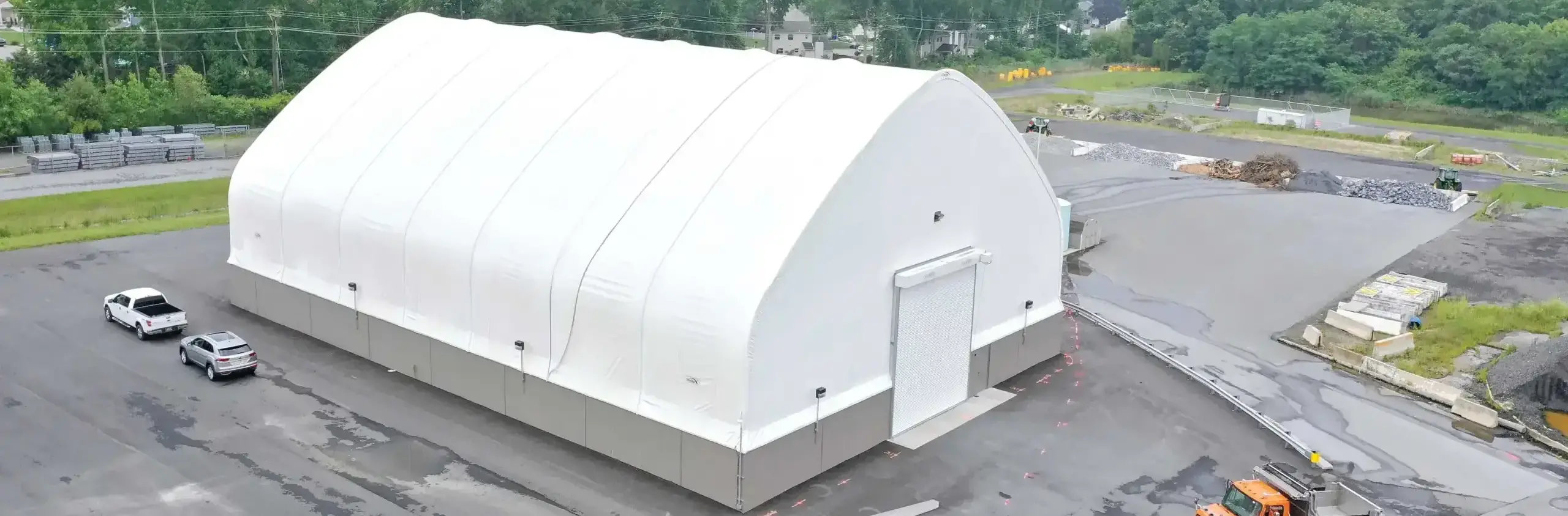 White fabric structure exterior with concrete foundation
