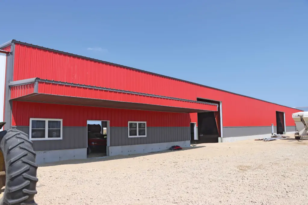 red and gray structure with metal building cladding and wainscot