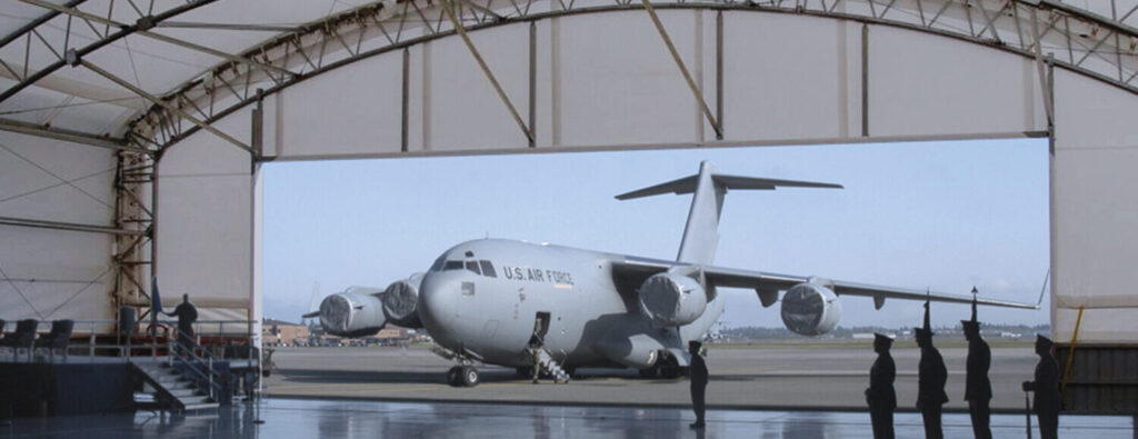 plane parked outside of plane hangar