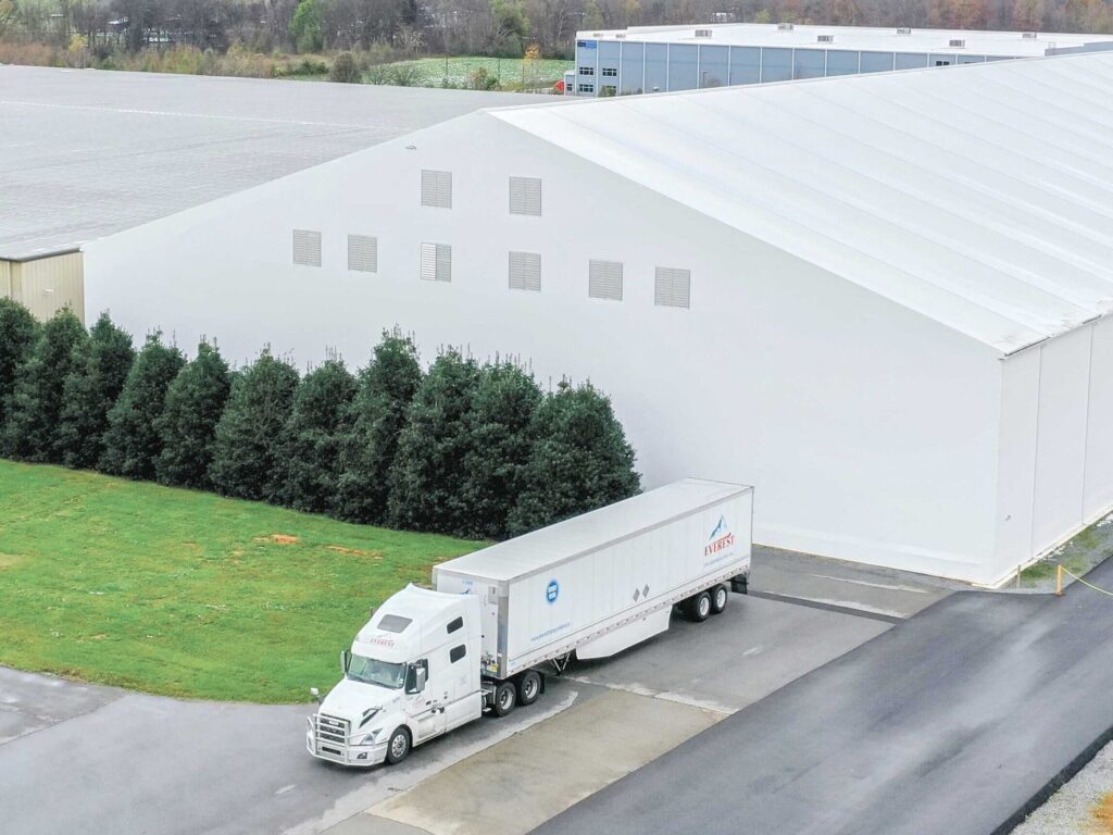 Fabric Beam Building used as a warehouse, sitting next to a factory