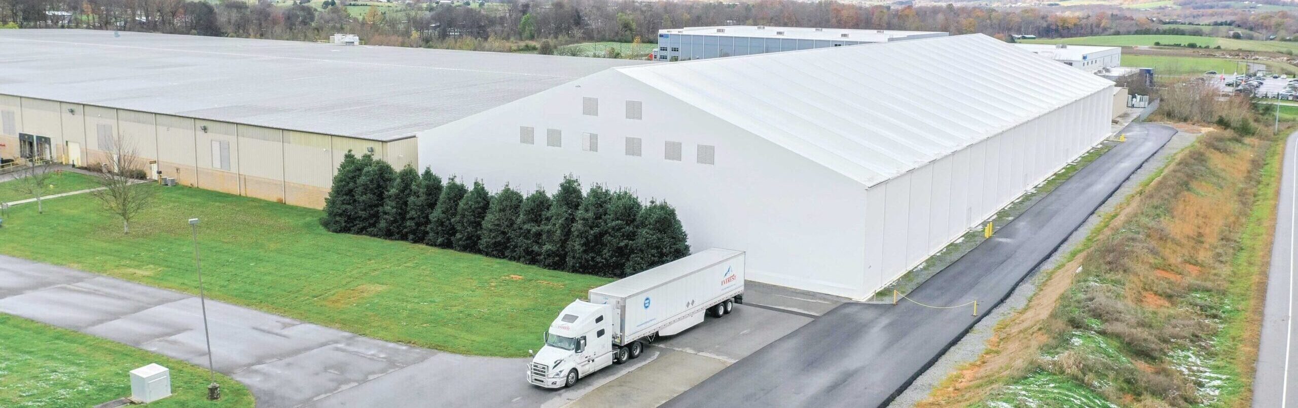 Fabric Beam Building used as a warehouse, sitting next to a factory
