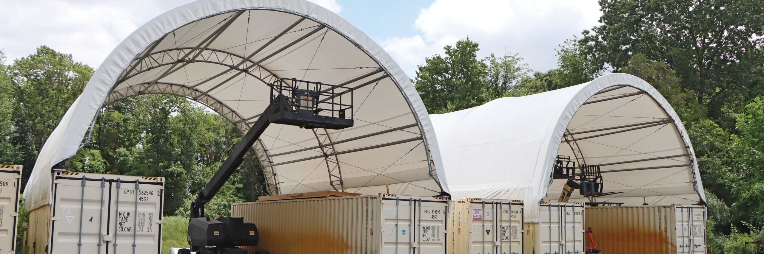 Container storage buildings with electric lifts underneath