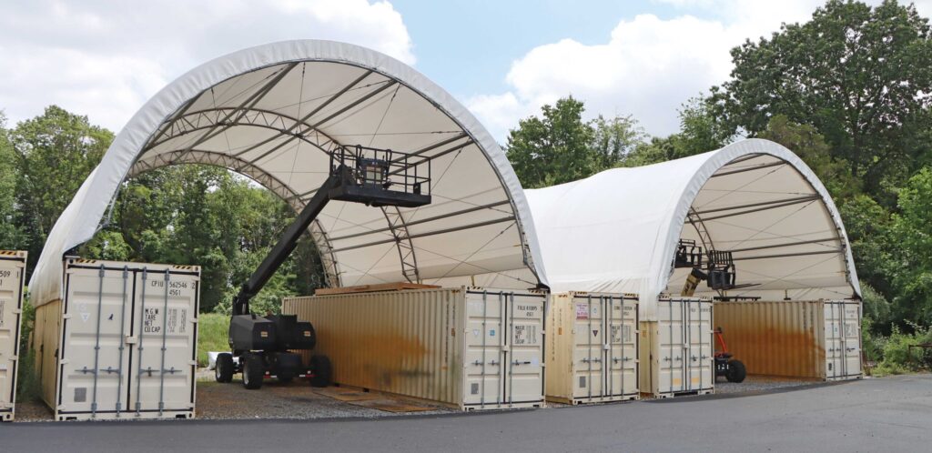 Container storage buildings with electric lifts underneath