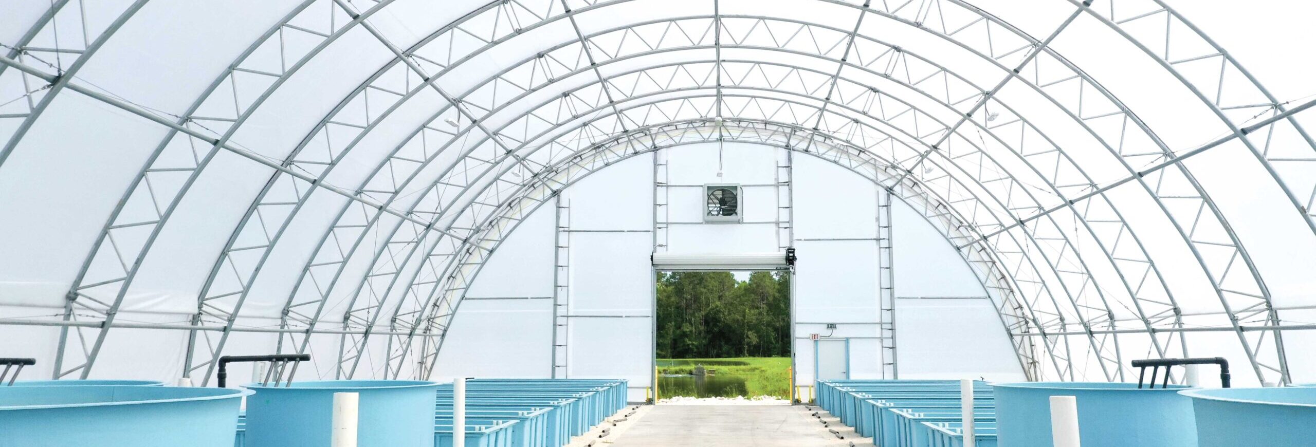 Aquaculture building with fishery and hatchery tanks