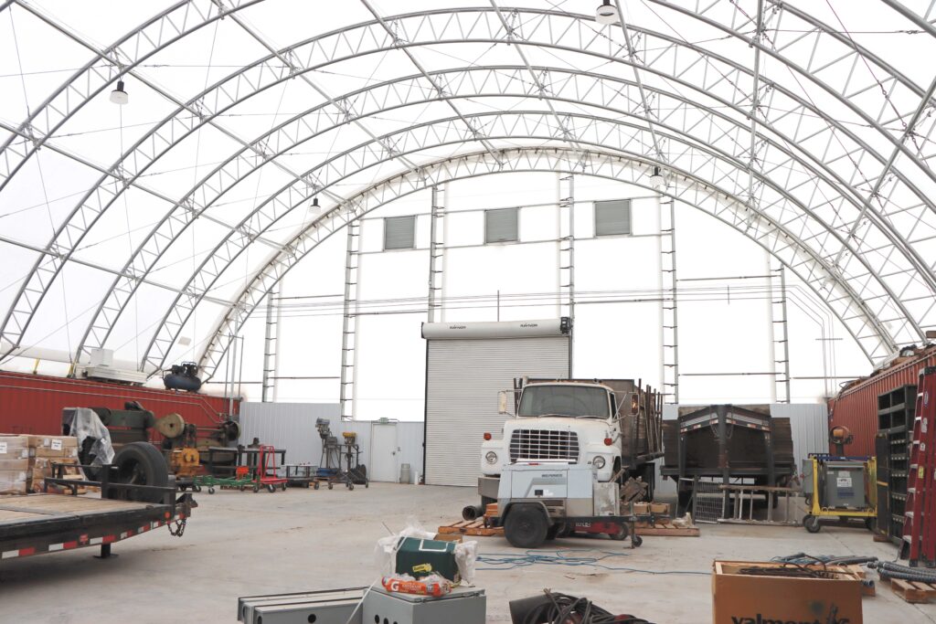 Stored items inside a ClearSpan HD Container Building: truck, trailer and assorted goods